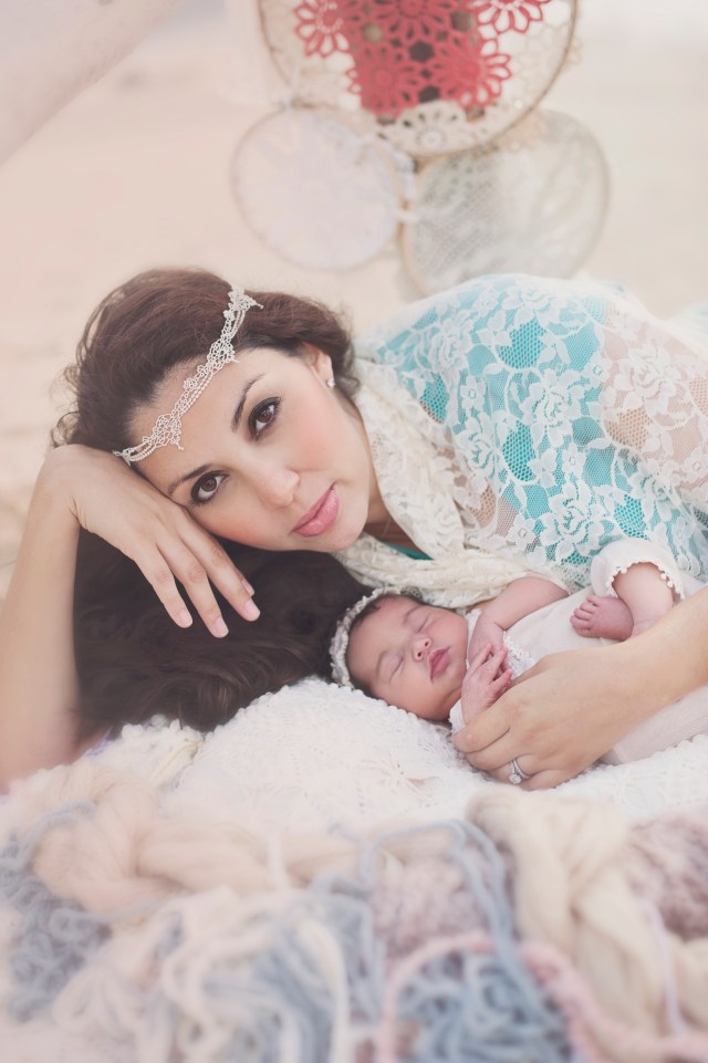 Mother and newborn baby pose